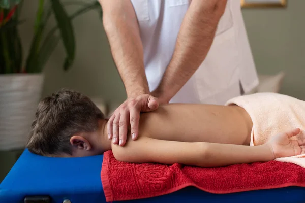paediatric Chiropractor applying pressure to childs back